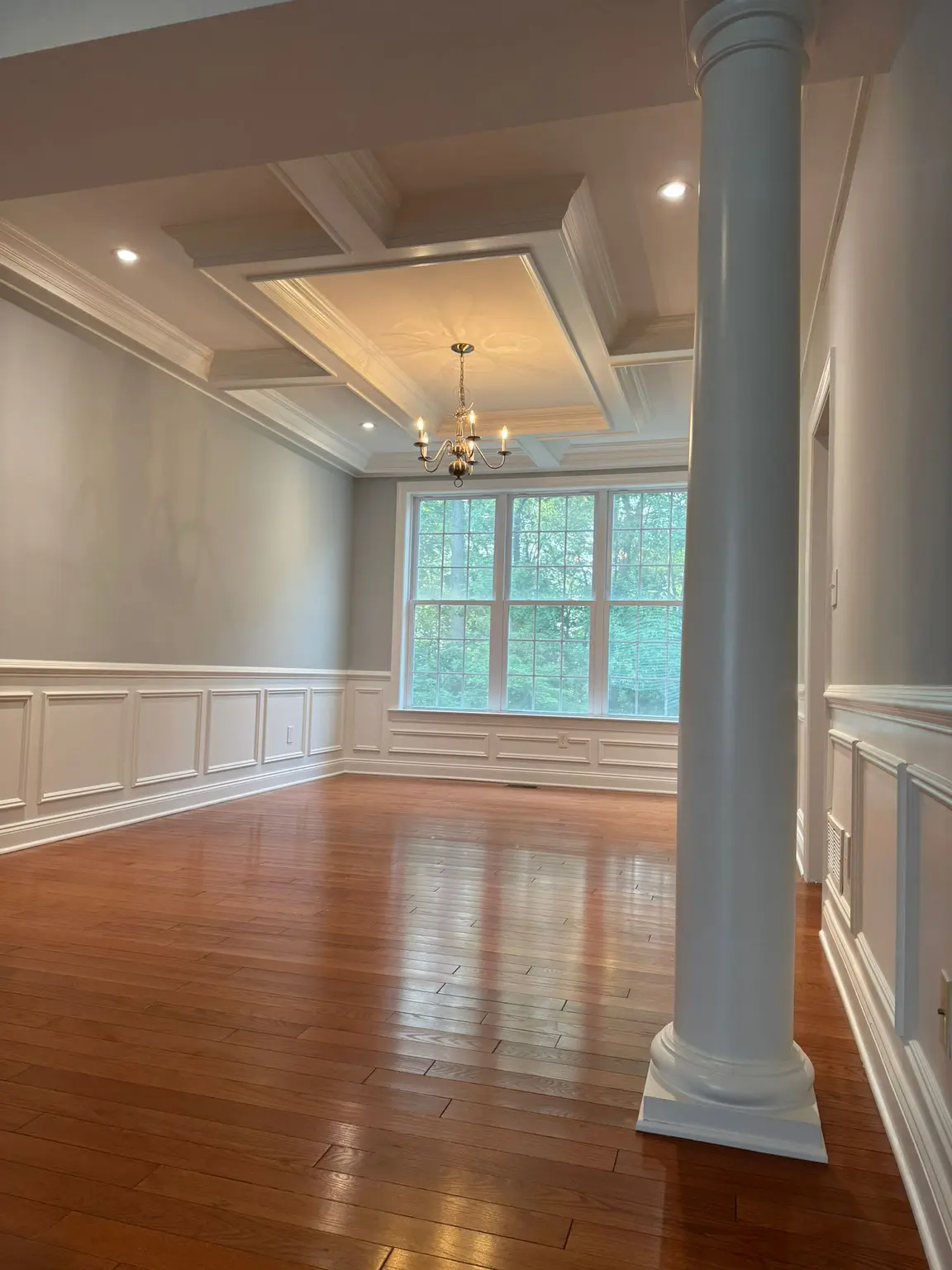 Decorative white coffered ceiling and wainscoting wall panels in a New Jersey home.