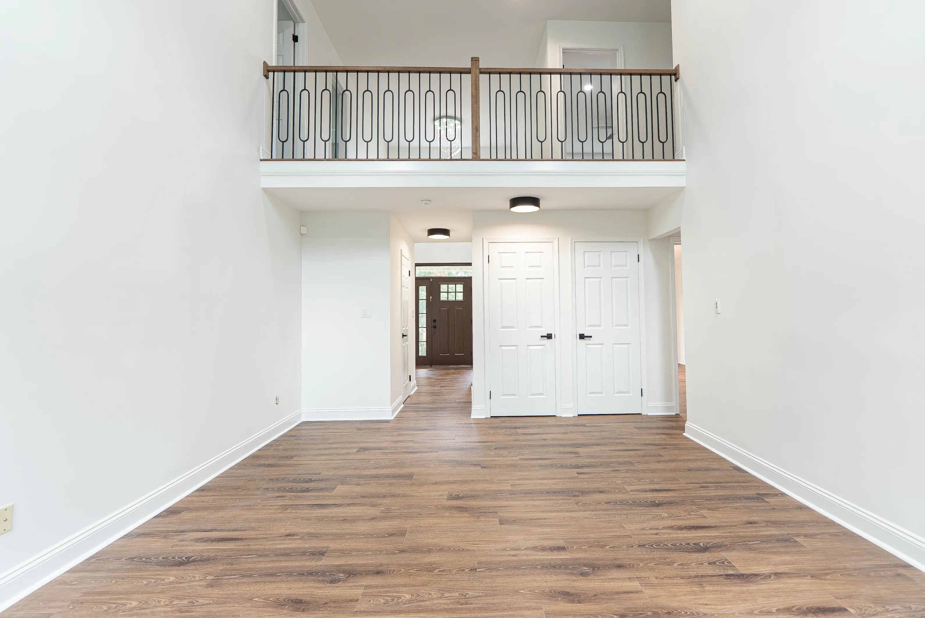 White baseboard trim installed along the walls of a clean, empty entryway in a New Jersey home