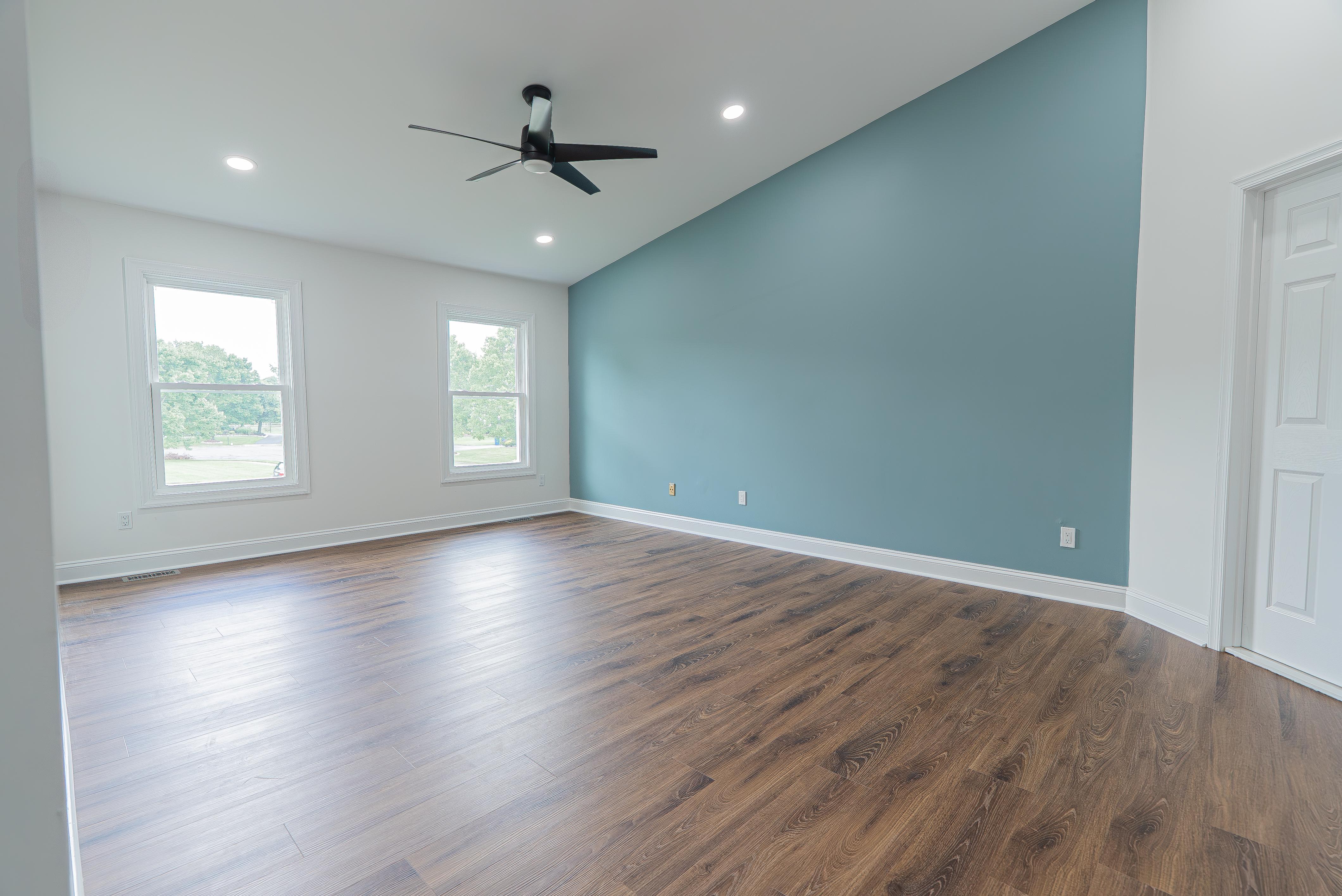 Newly installed white window and door trim with matching baseboards in a modern New Jersey room