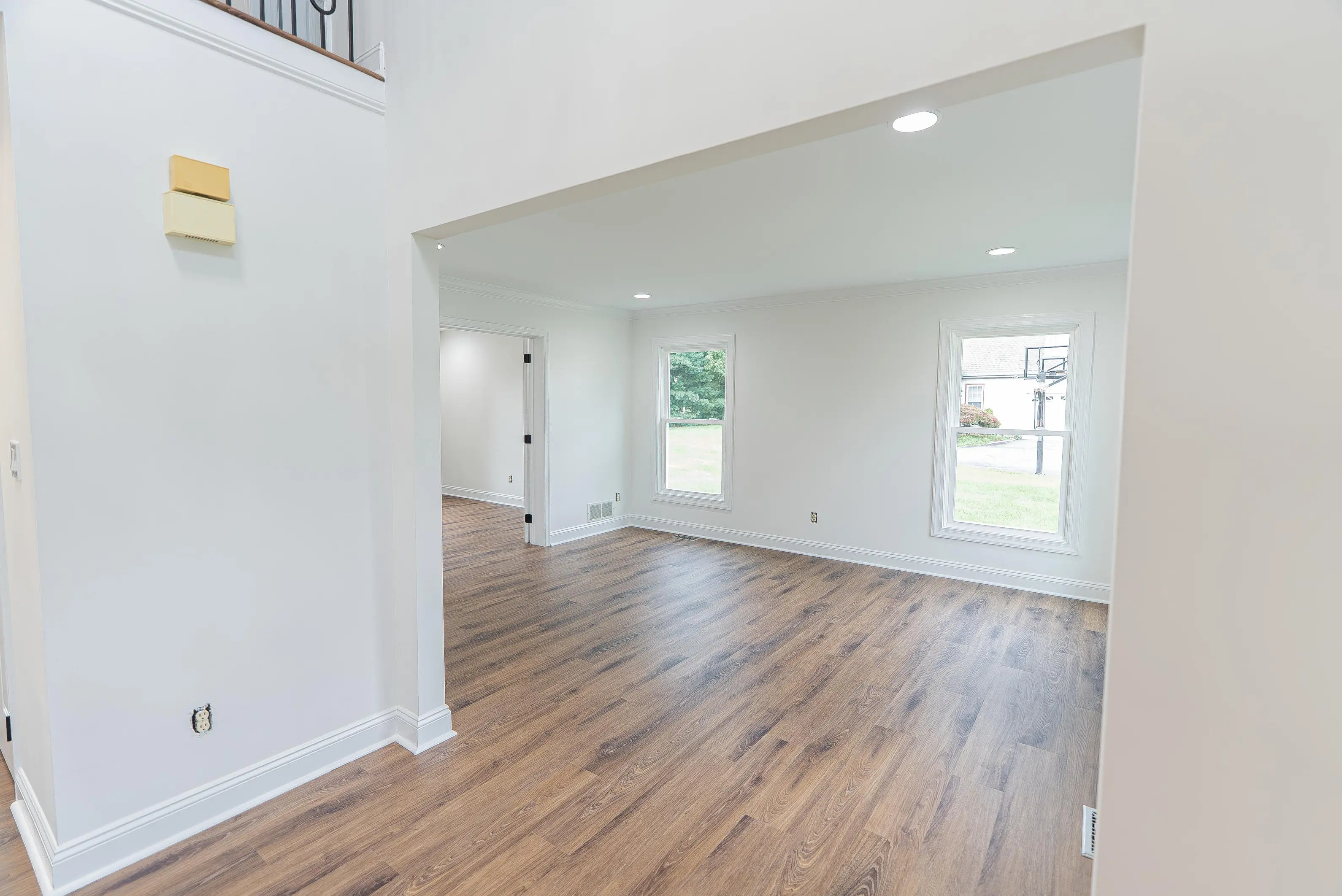 White crown molding, window, door trim, and baseboards in an empty New Jersey room