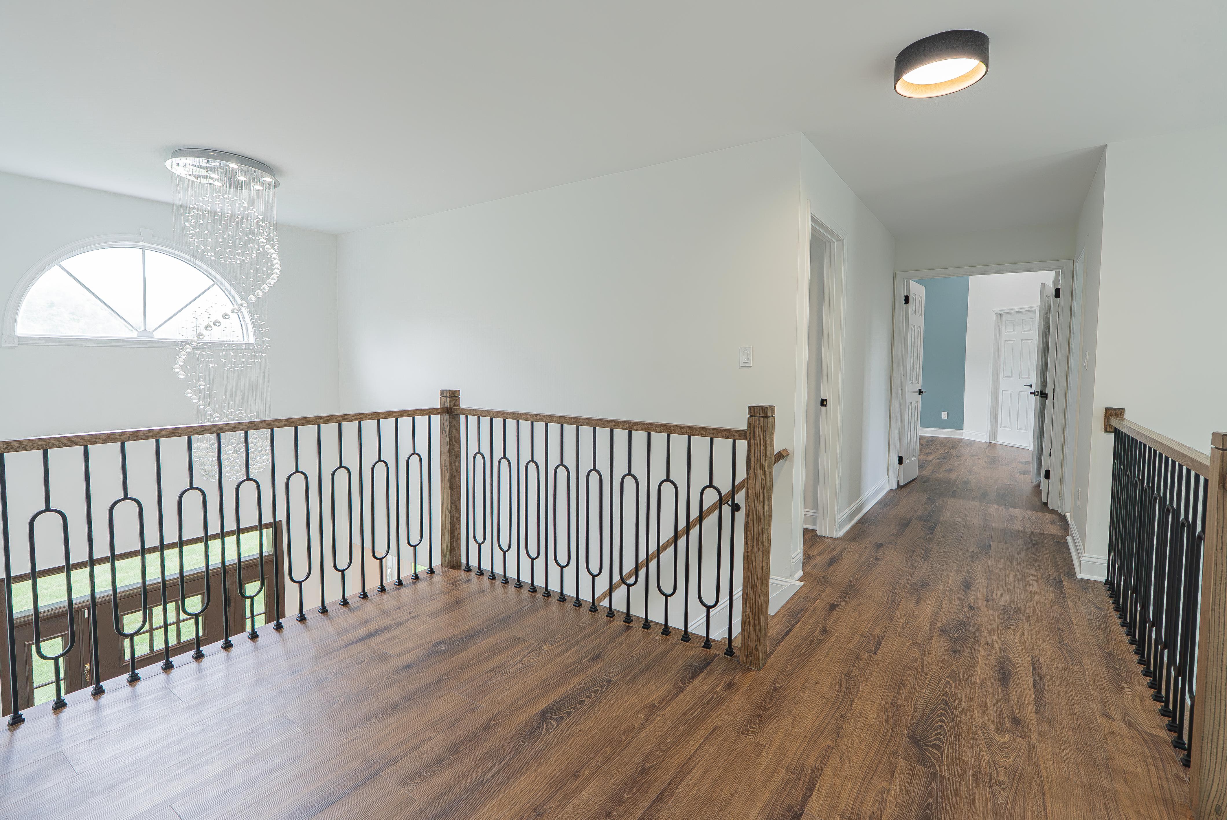 White door and window trim with matching baseboards in a modern upstairs hallway in New Jersey