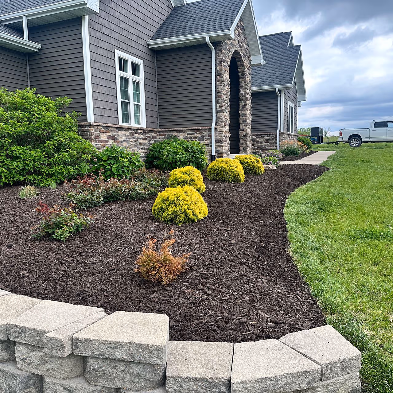 landscape bed redesign with fresh mulch and edging