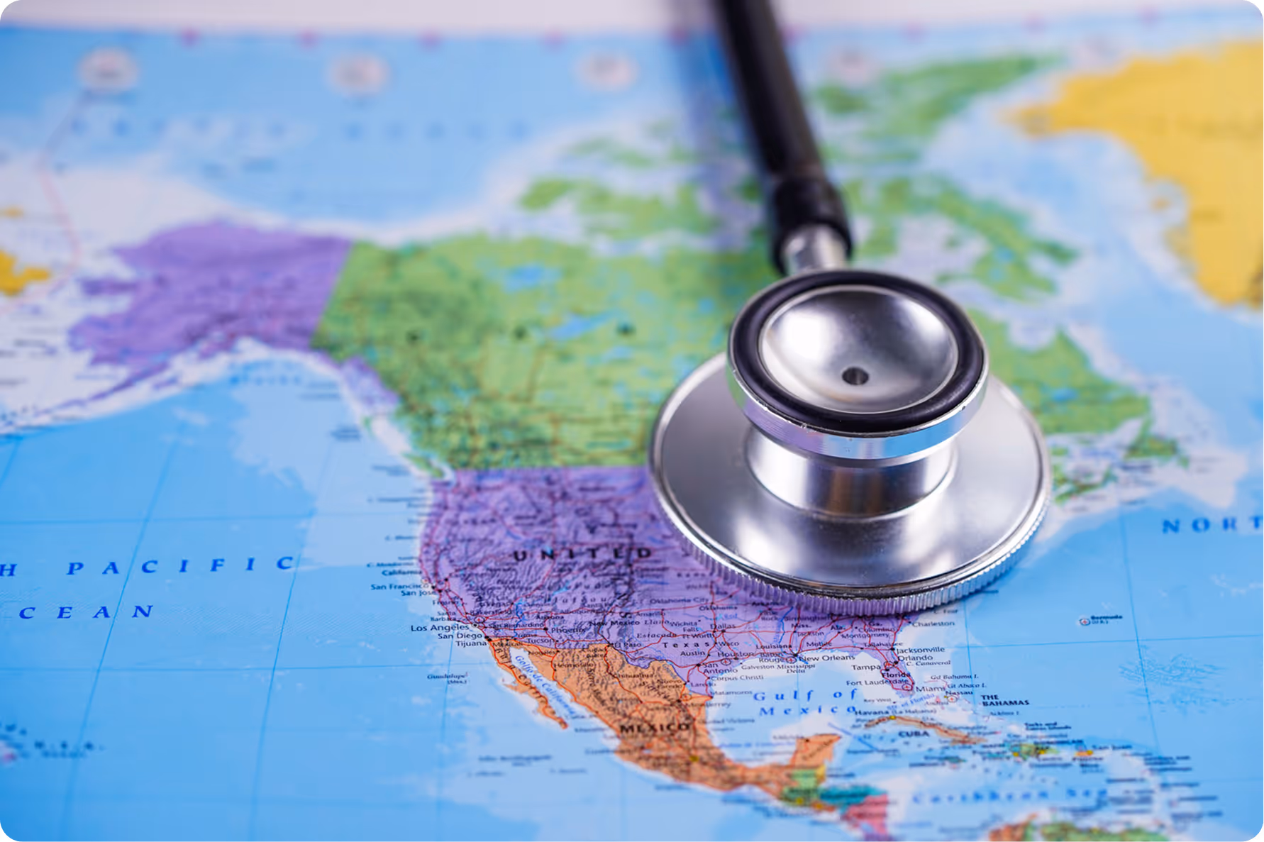 Stethoscope placed on a colorful map of North America focusing on the United States and Mexico.