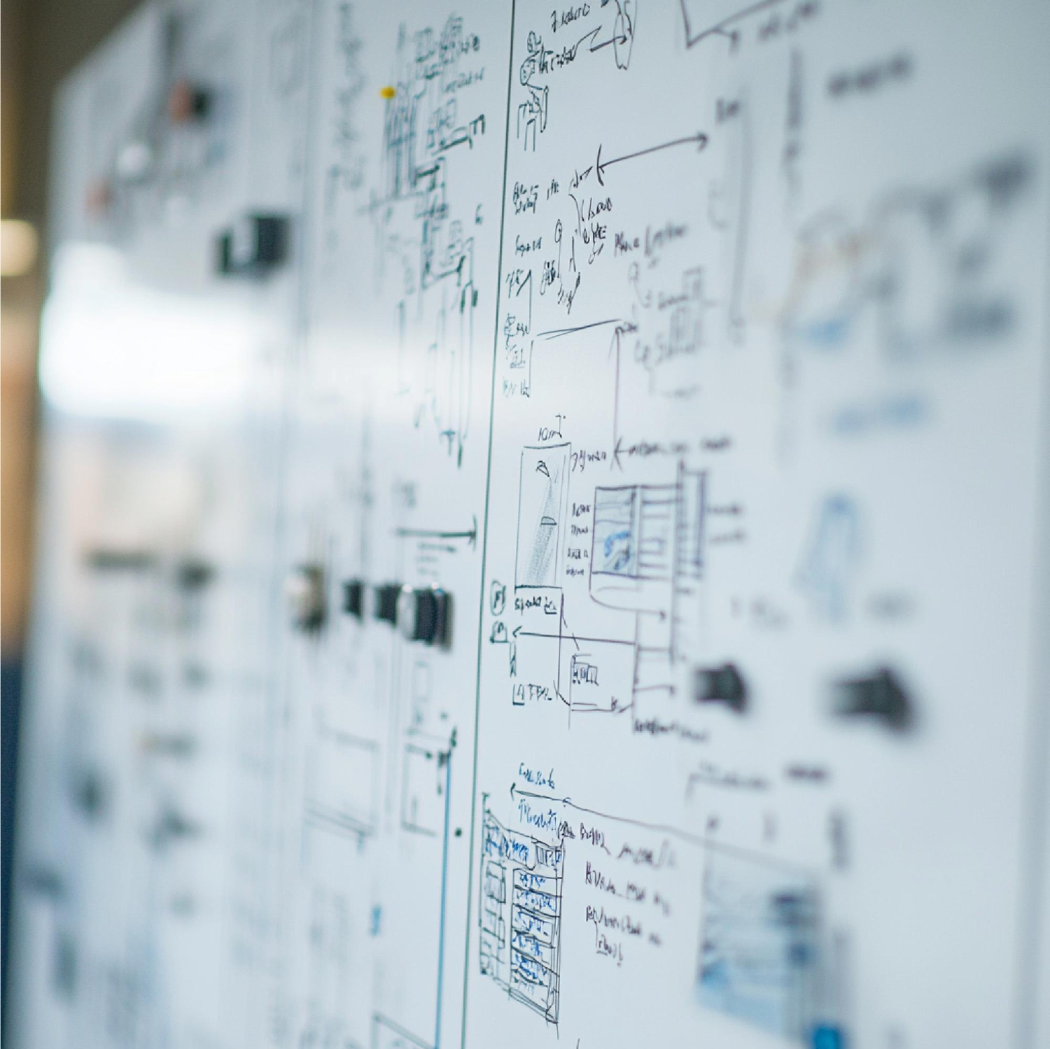 Whiteboard filled with detailed technical diagrams and handwritten notes in black marker.