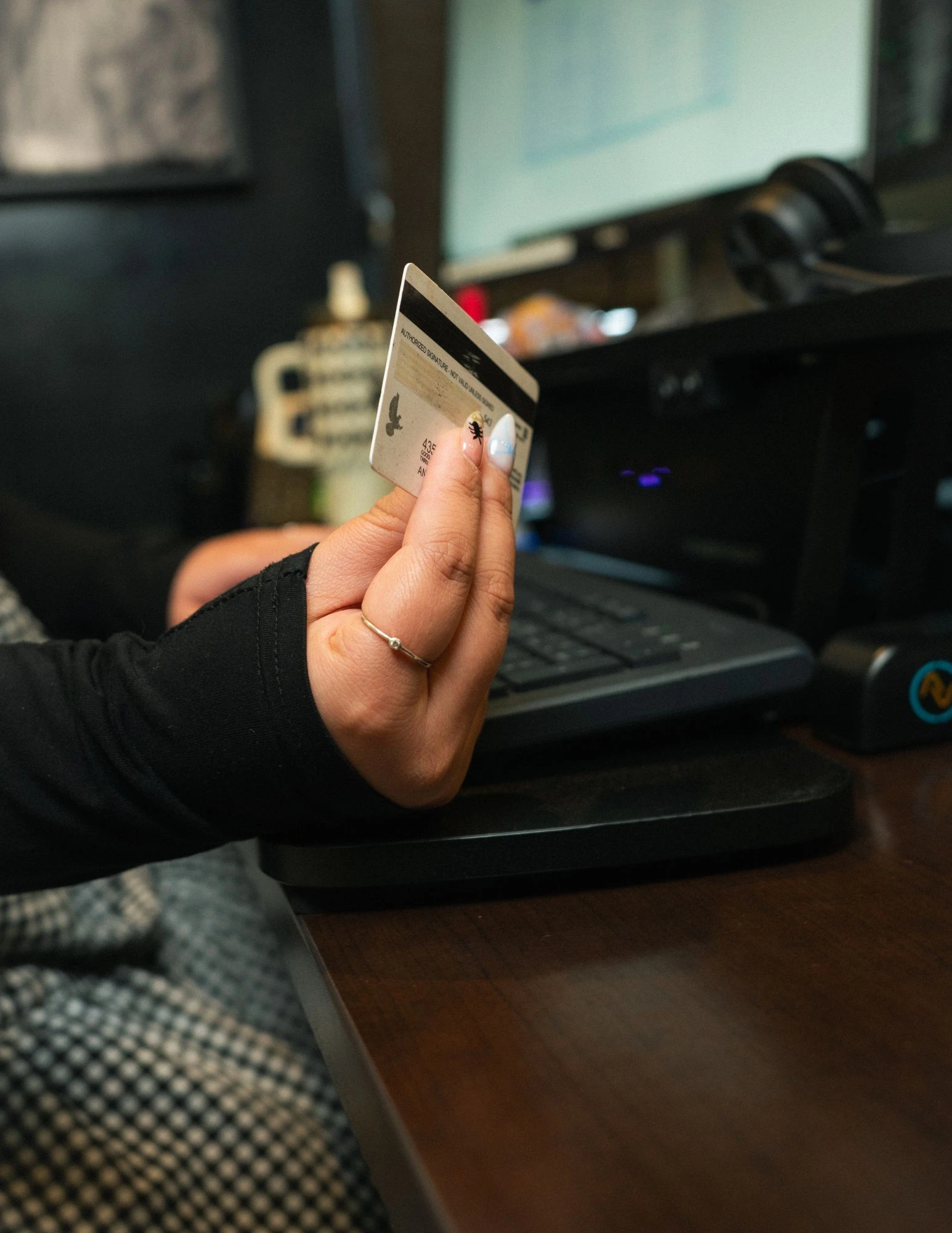 Womans Hand holding a debit card