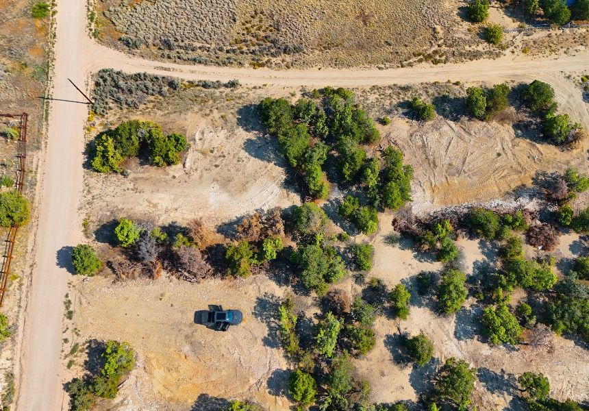 Road grader leveling a dirt road