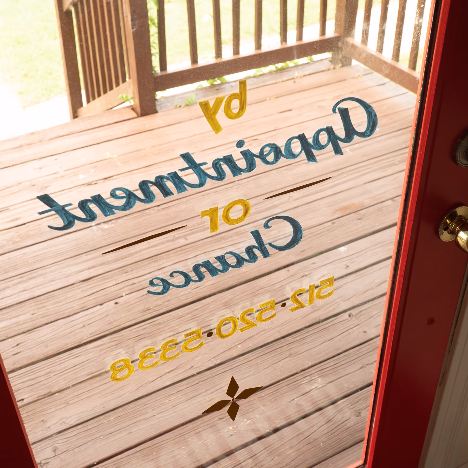 Glass door with hand-lettered text reading 'rd Department of Chance' and a phone number, with wooden porch outside.