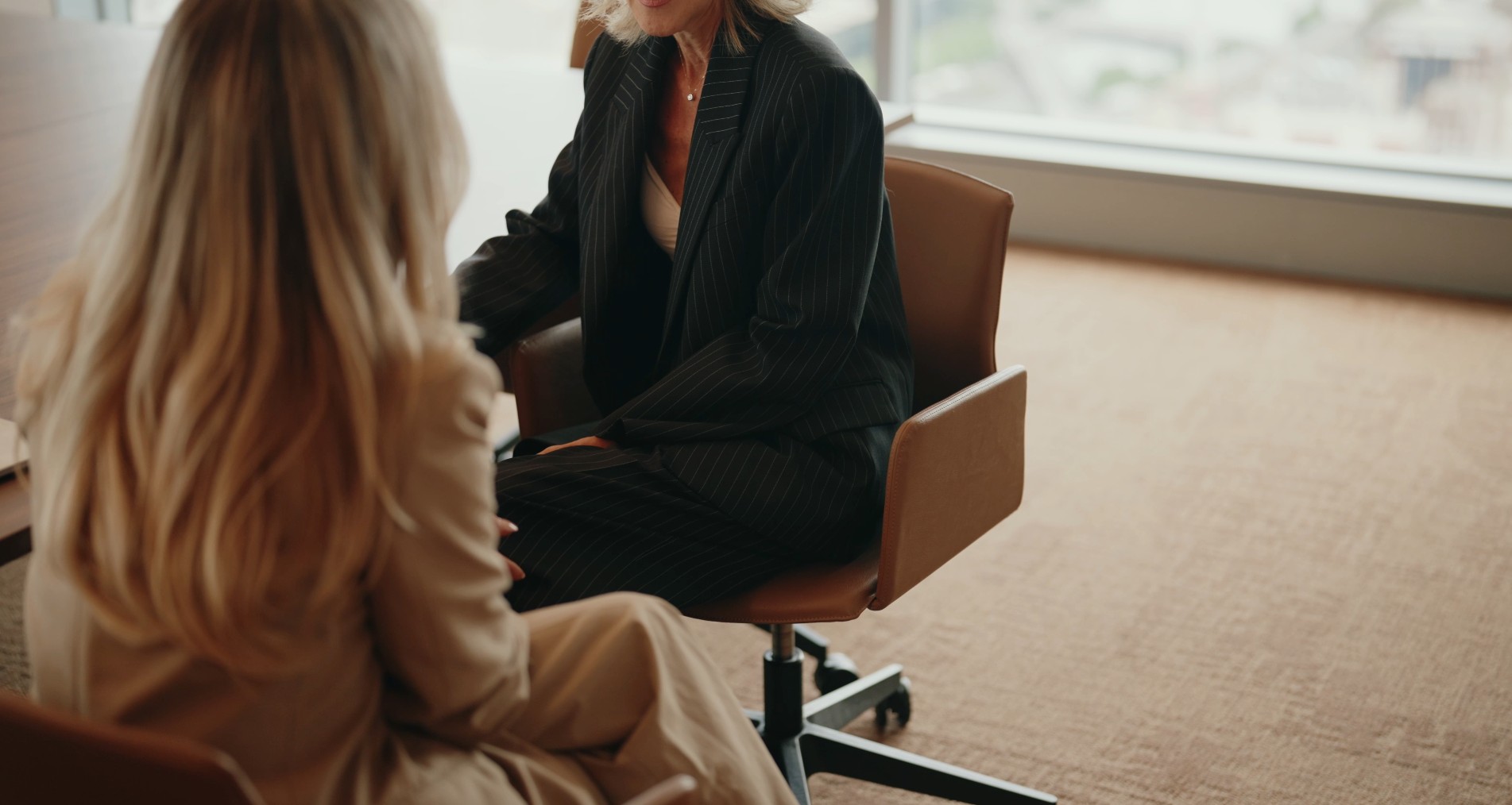 Two women in discussion during a one-on-one office meeting