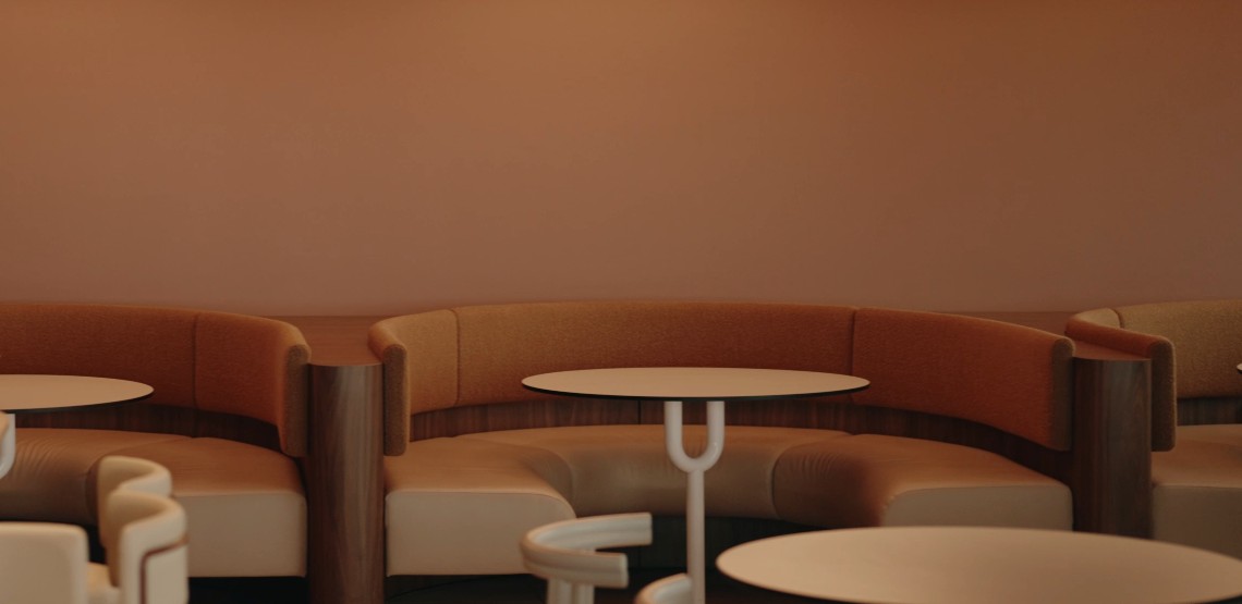 Curved lounge seating and round tables in a modern office breakout area
