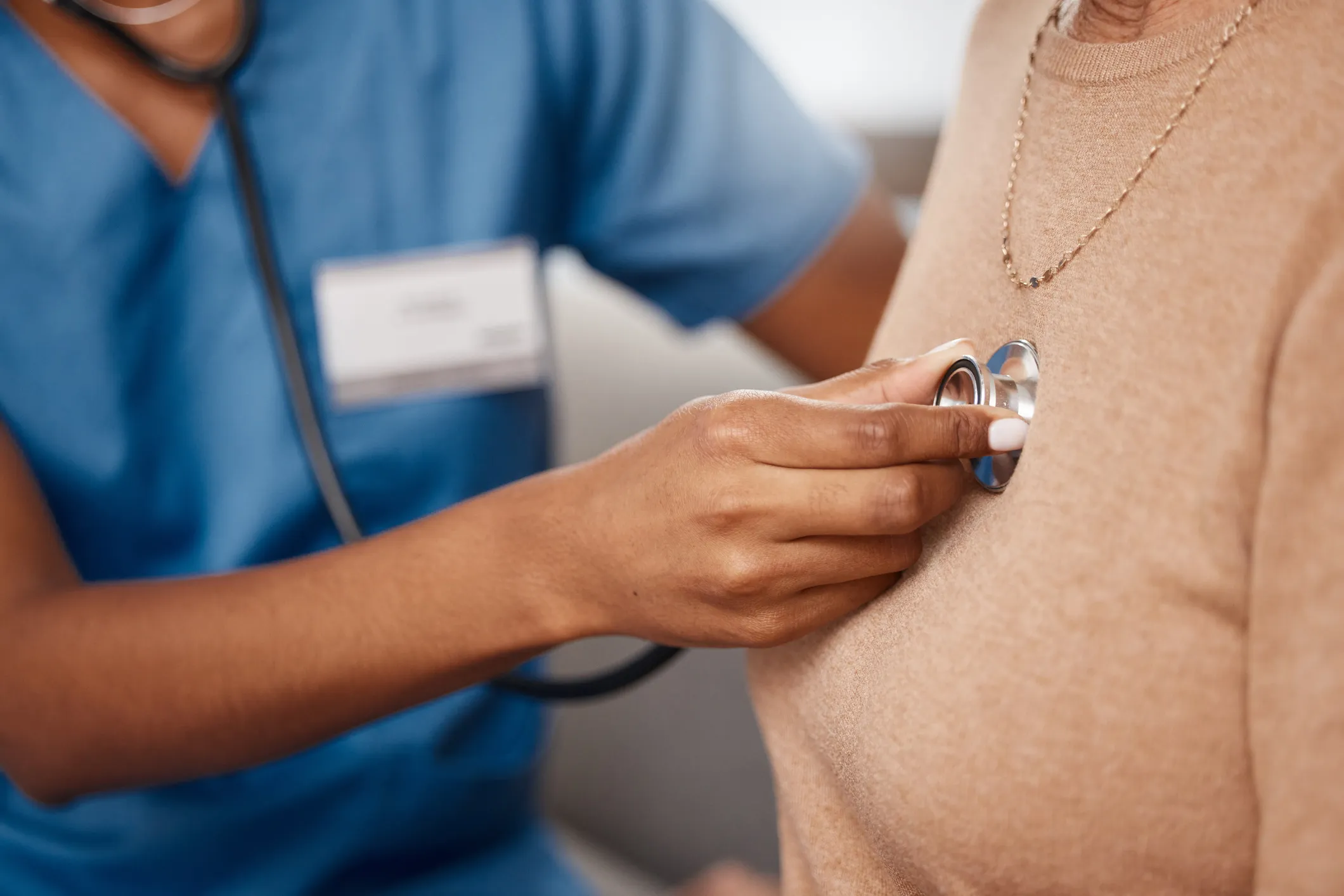 A woman having her lungs checked via a stethoscope