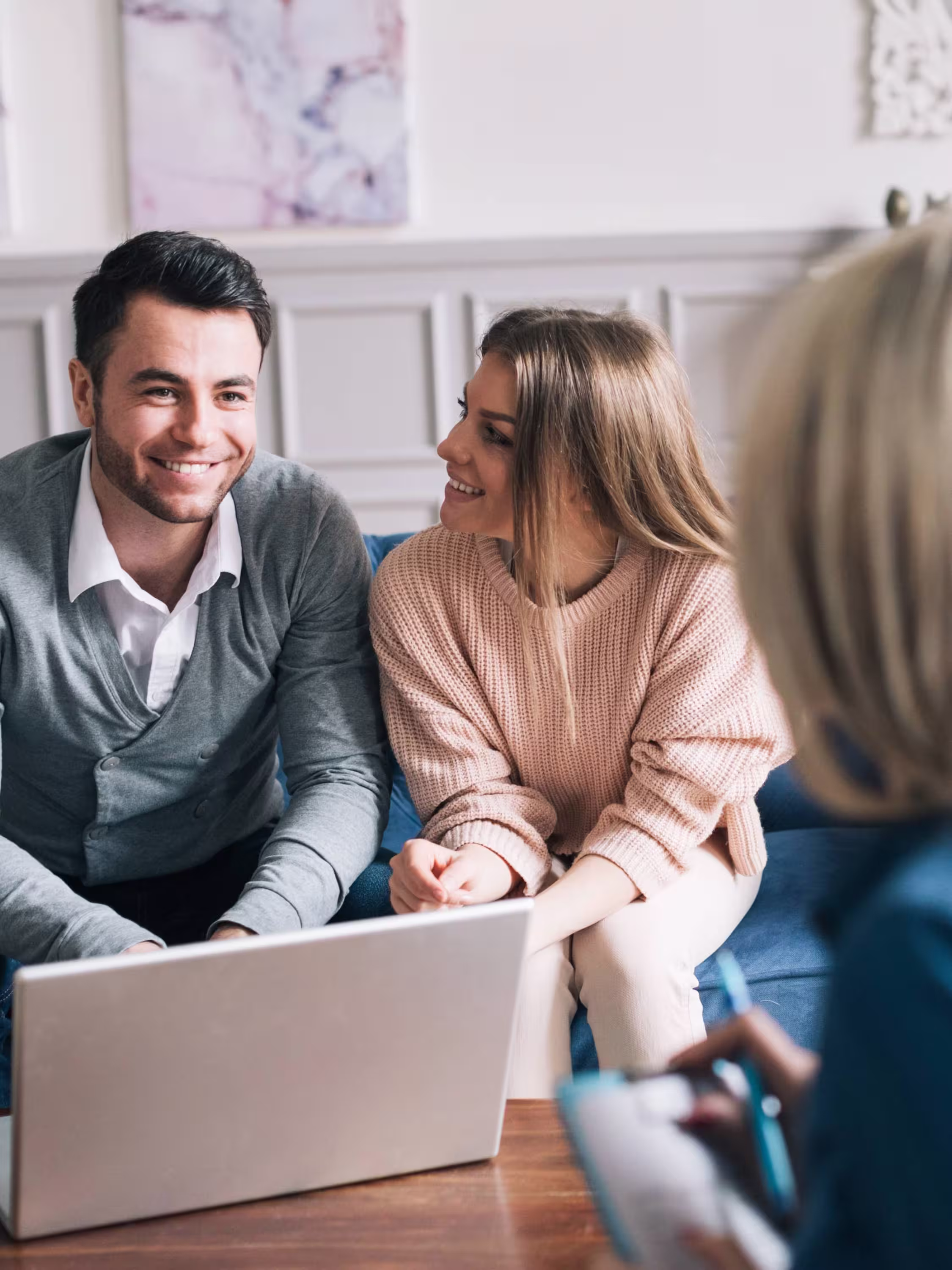 A couple in a financial consultation discussing personalised mortgage and business lending solutions with an adviser at Plinth Finance.