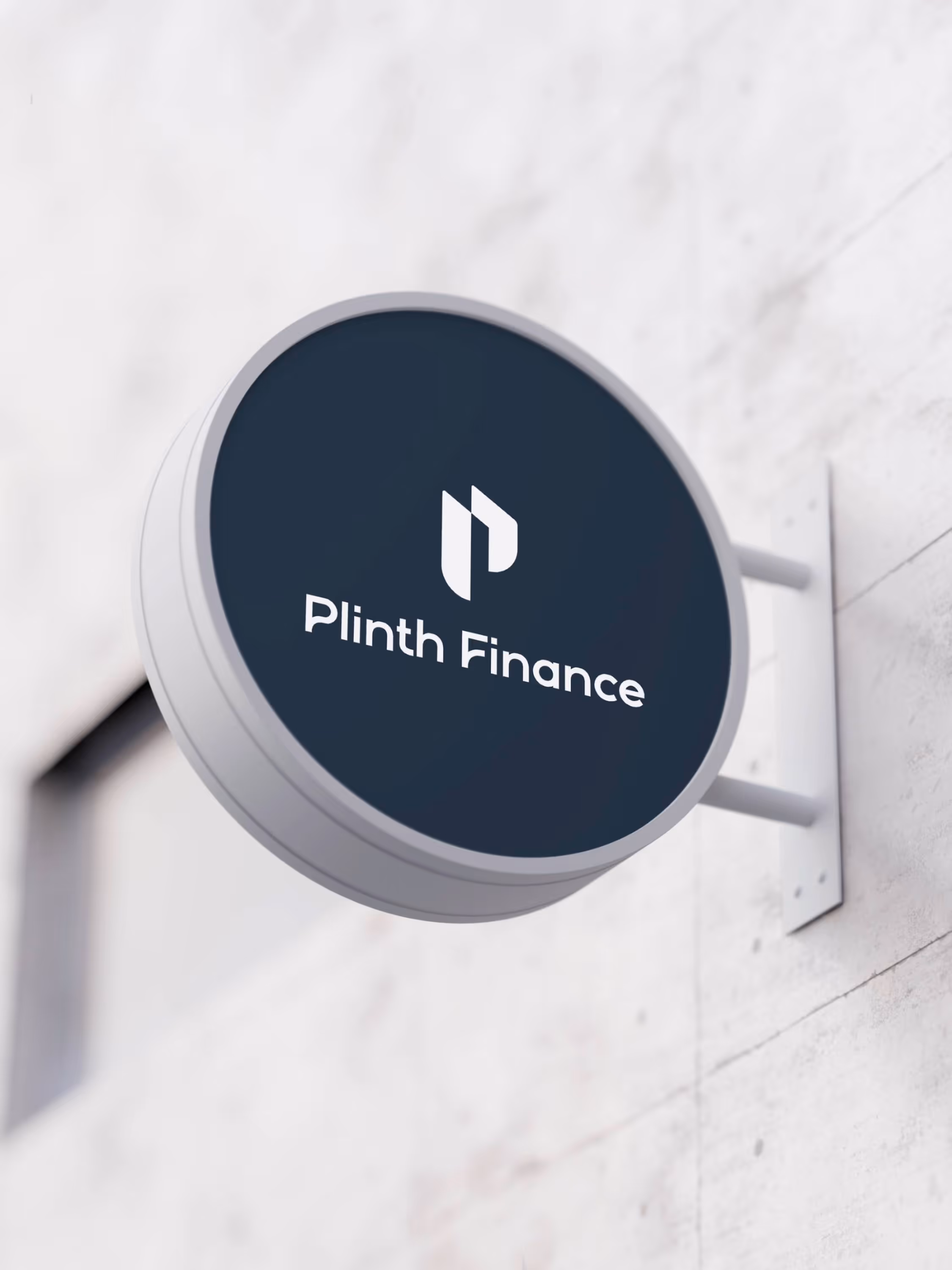Plinth Finance brand logo showcased on a professional, minimalist circular outdoor signage mockup to represent an established financial office.