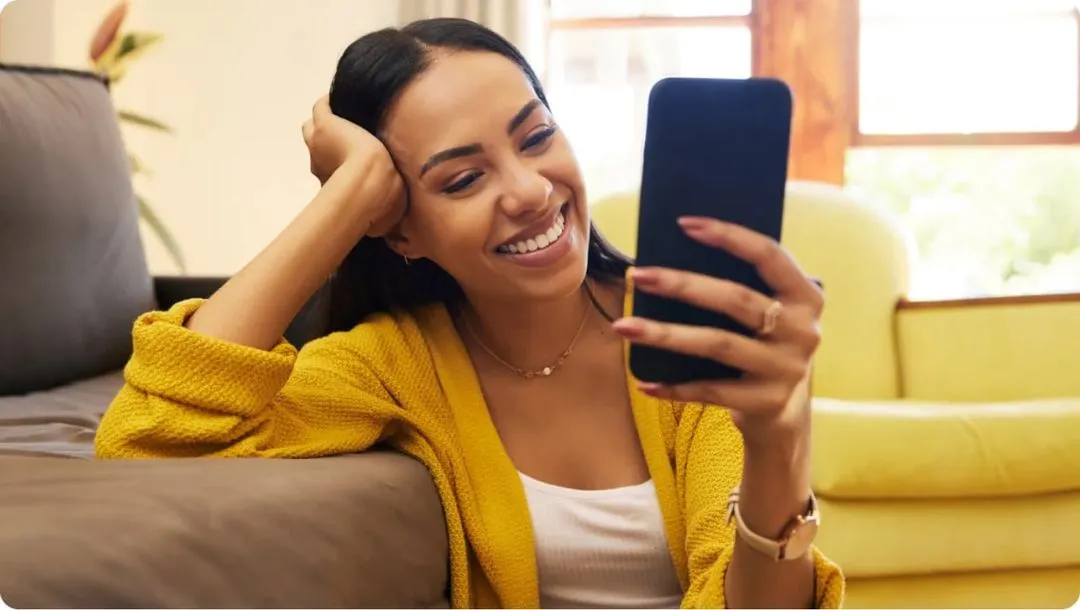Girl looking at phone and smiling