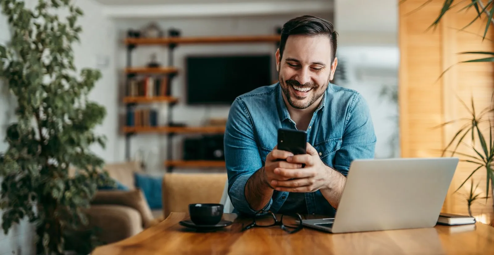 Man smiling looking at mobile phone