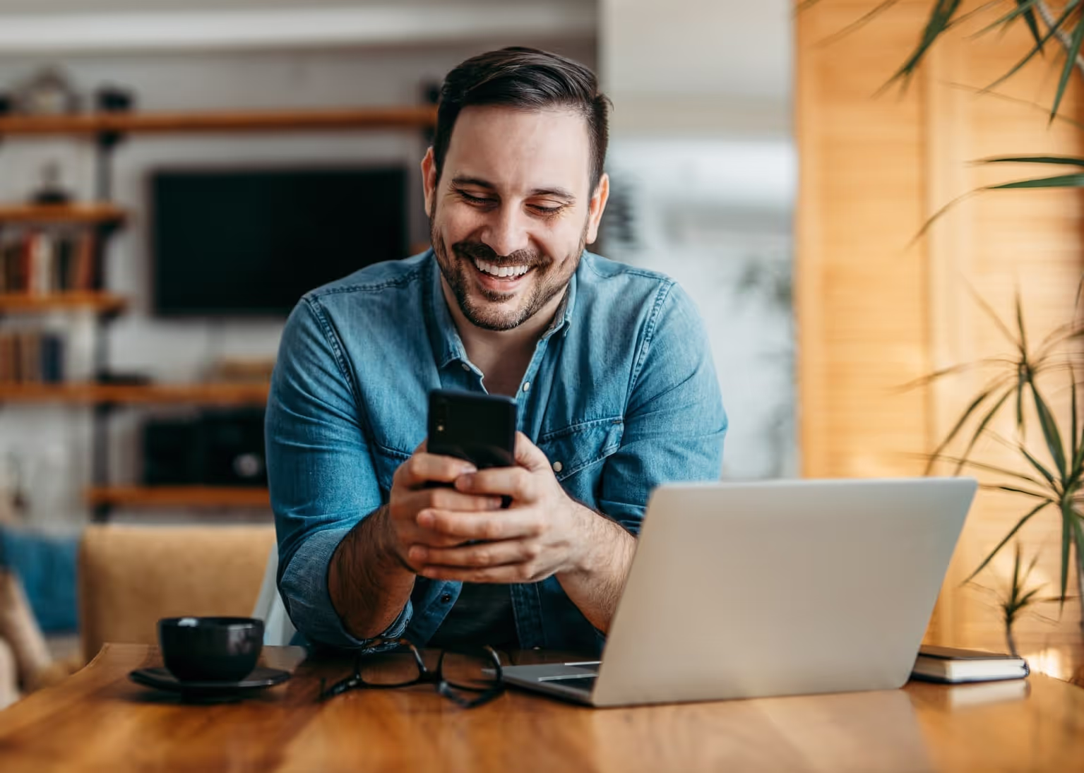 Man smiling looking at mobile phone