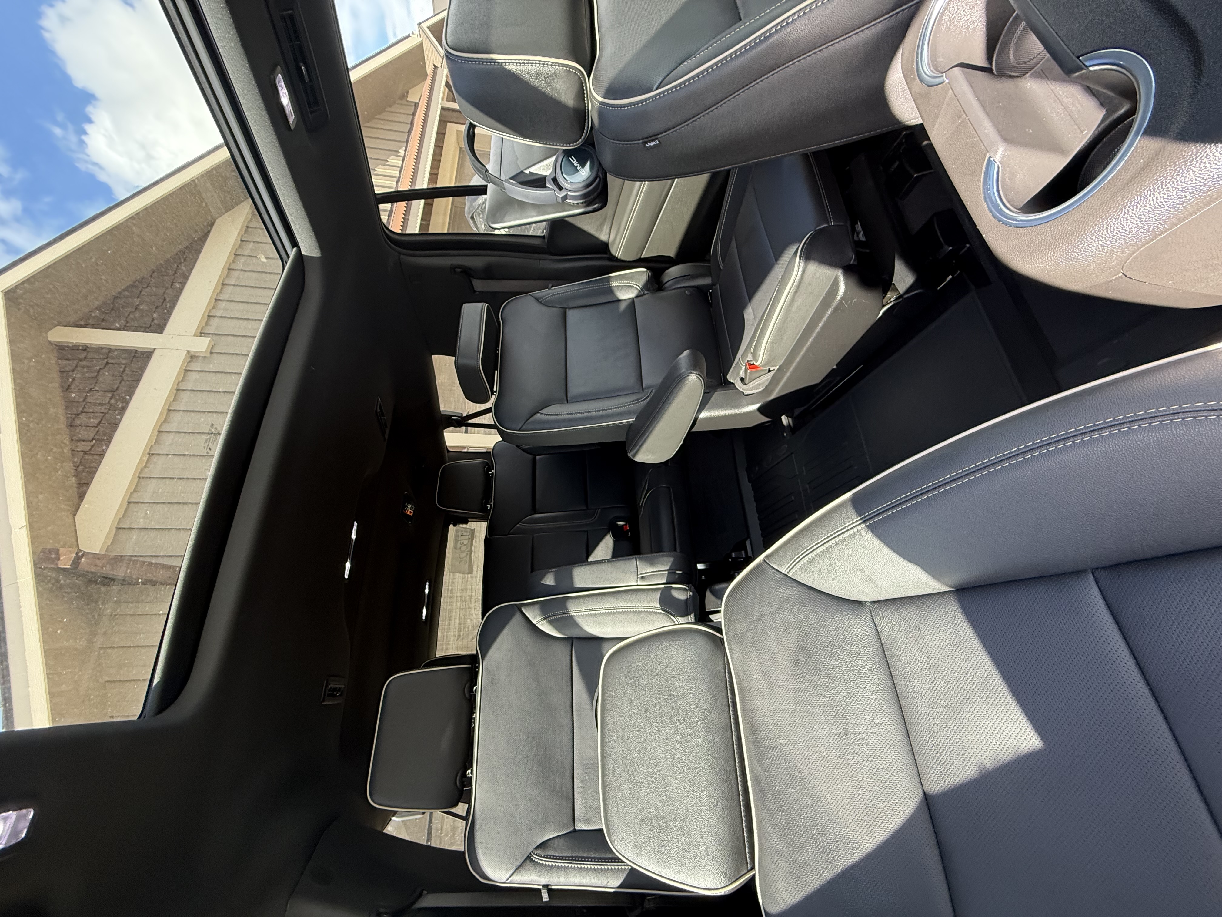 Interior of a Subaru car showing steering wheel, dashboard, gear shift, and black front seats.