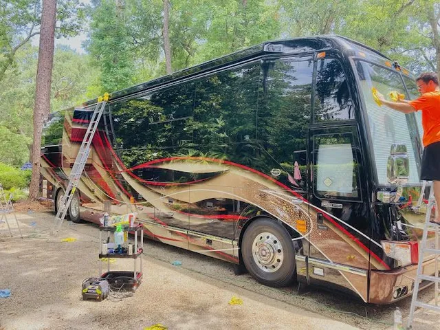Interior of a modern vehicle showing steering wheel with Ford Bronco logo, dashboard, gear shift, and two-tone leather front seat.