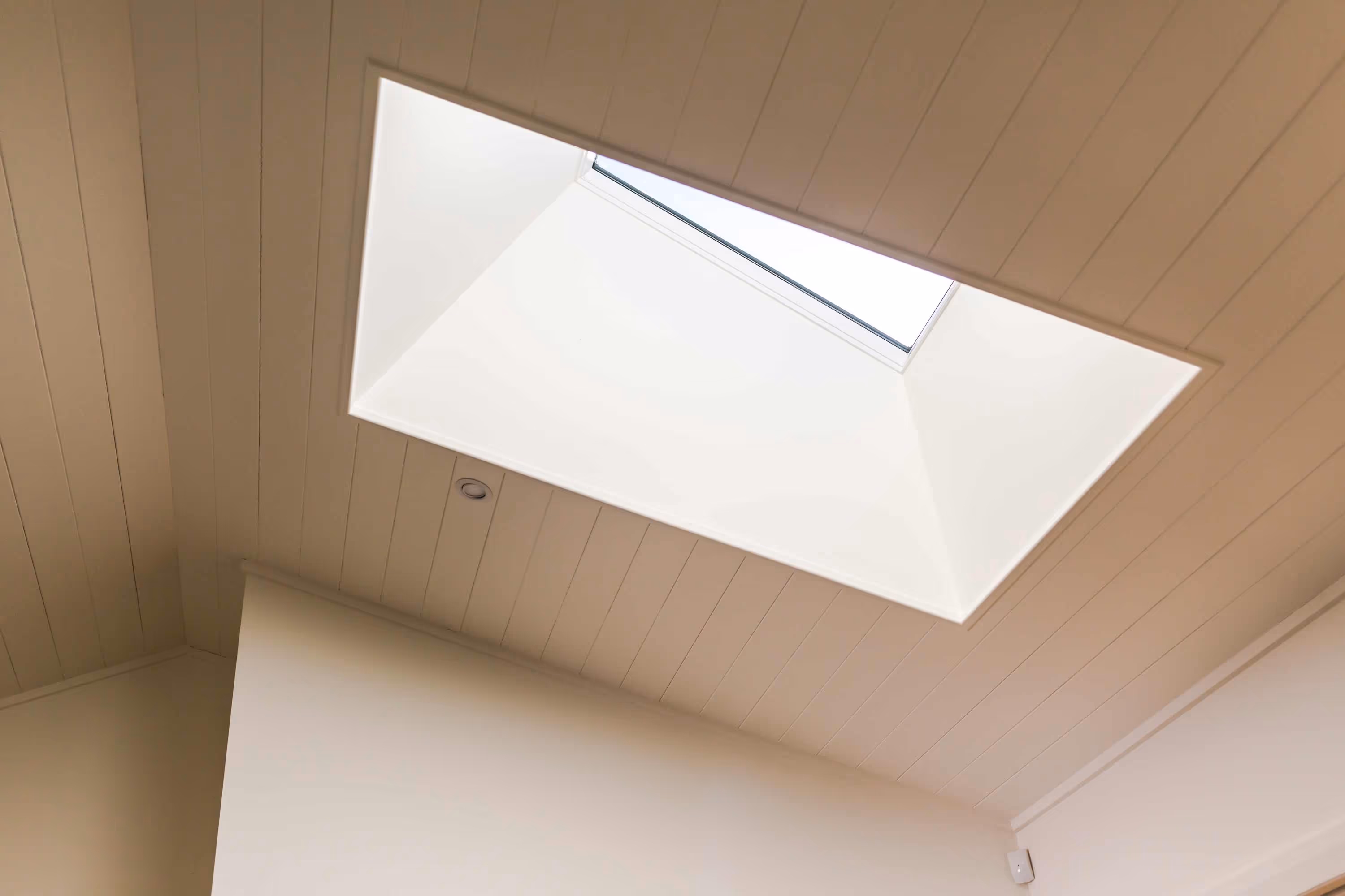 White timber-paneled ceiling at the Kemp House in Greytown with large rectangular skylight.