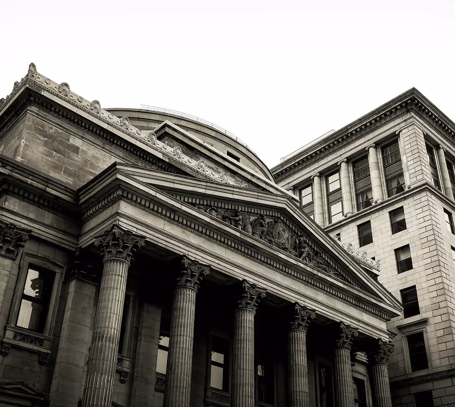 Classical neoclassical building with tall Corinthian columns and ornate pediment entrance.