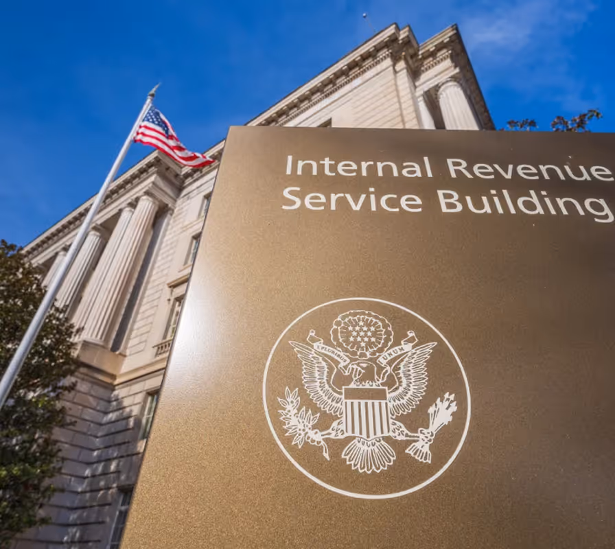Internal Revenue Service Building with American flag and Great Seal, classical architecture against blue sky