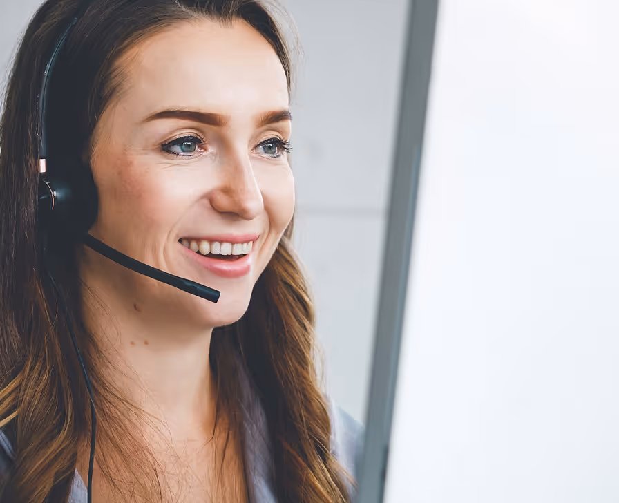 Woman wearing headset microphone smiling at camera in professional setting
