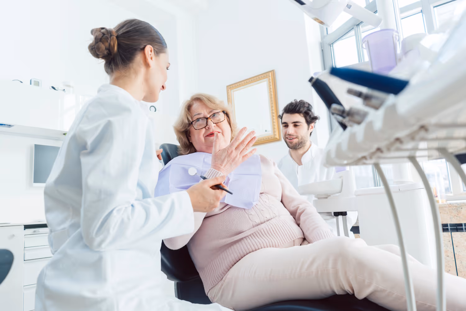 Senior woman talking to dentist