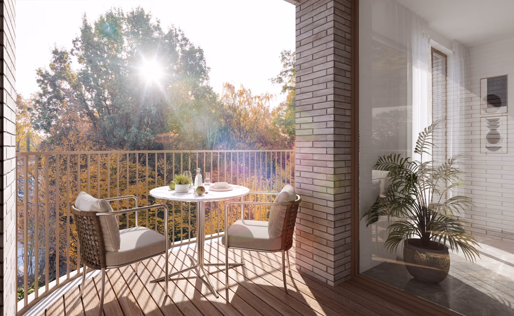 Zonnig balkon van nieuwbouwproject Planeta in Wilrijk met twee beklede stoelen en een ronde tafel met planten en fruit, uitkijkend op herfstige bomen.