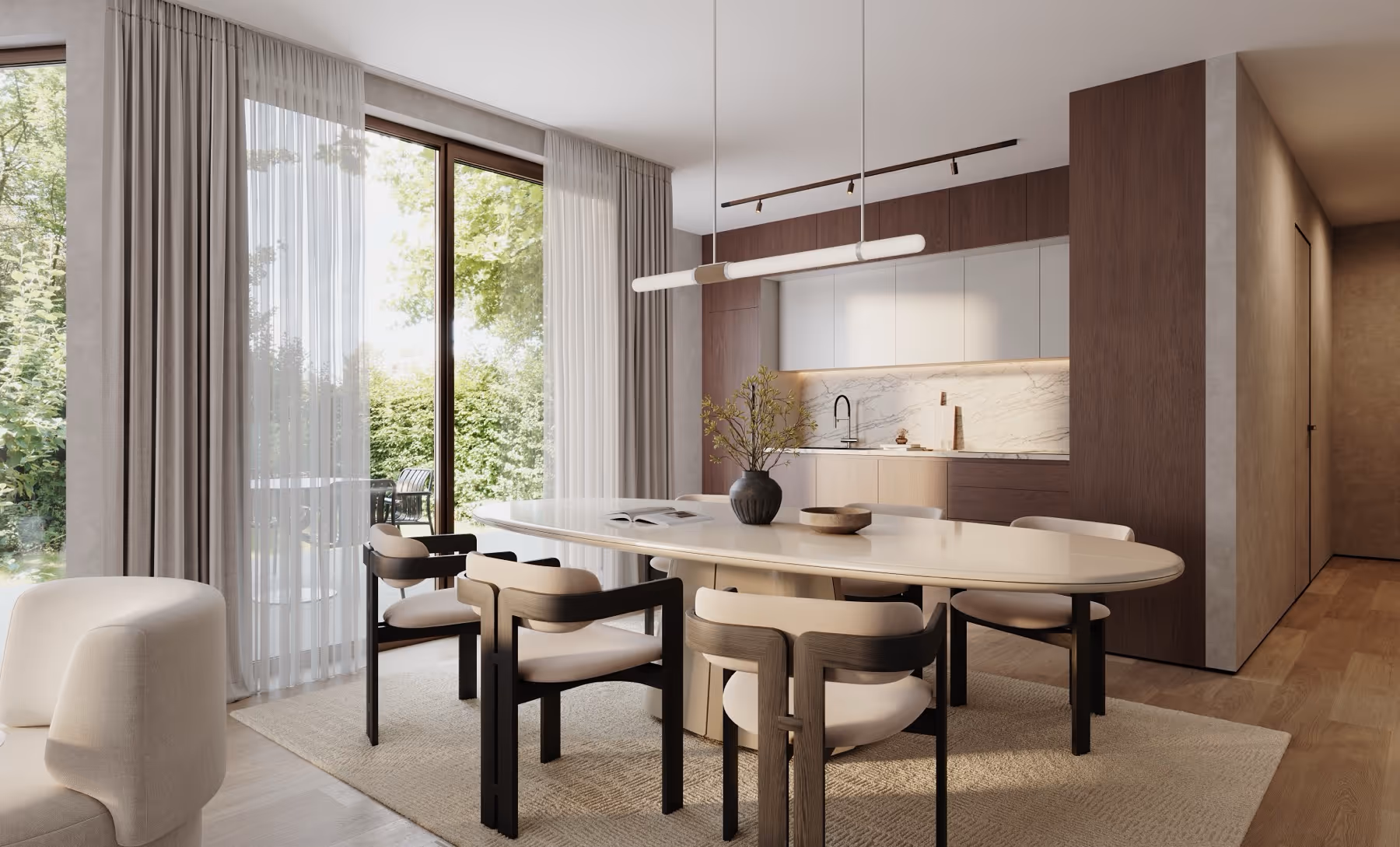 Moderne eethoek van nieuwbouwproject Planeta in Wilrijk met ovale witte tafel, zes beklede stoelen, groot raam met lichte gordijnen en keuken met houten en witte kasten.