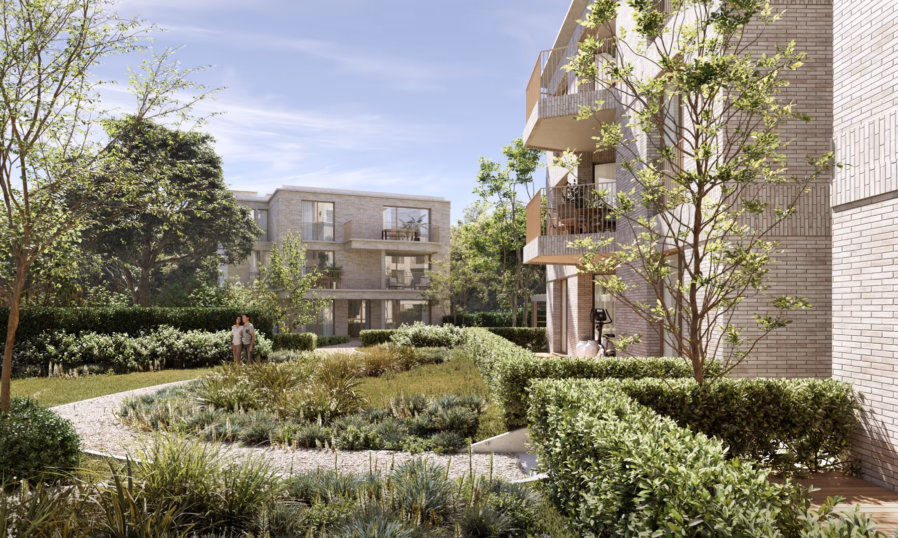 Moderne appartementengebouwen van nieuwbouwproject Planeta in Wilrijk rond een aangelegde binnentuin met groene bomen, struiken en kronkelend grindpad onder een heldere hemel.