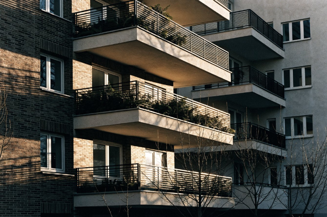 Apartment building elevation with stacked balconies and planted terraces