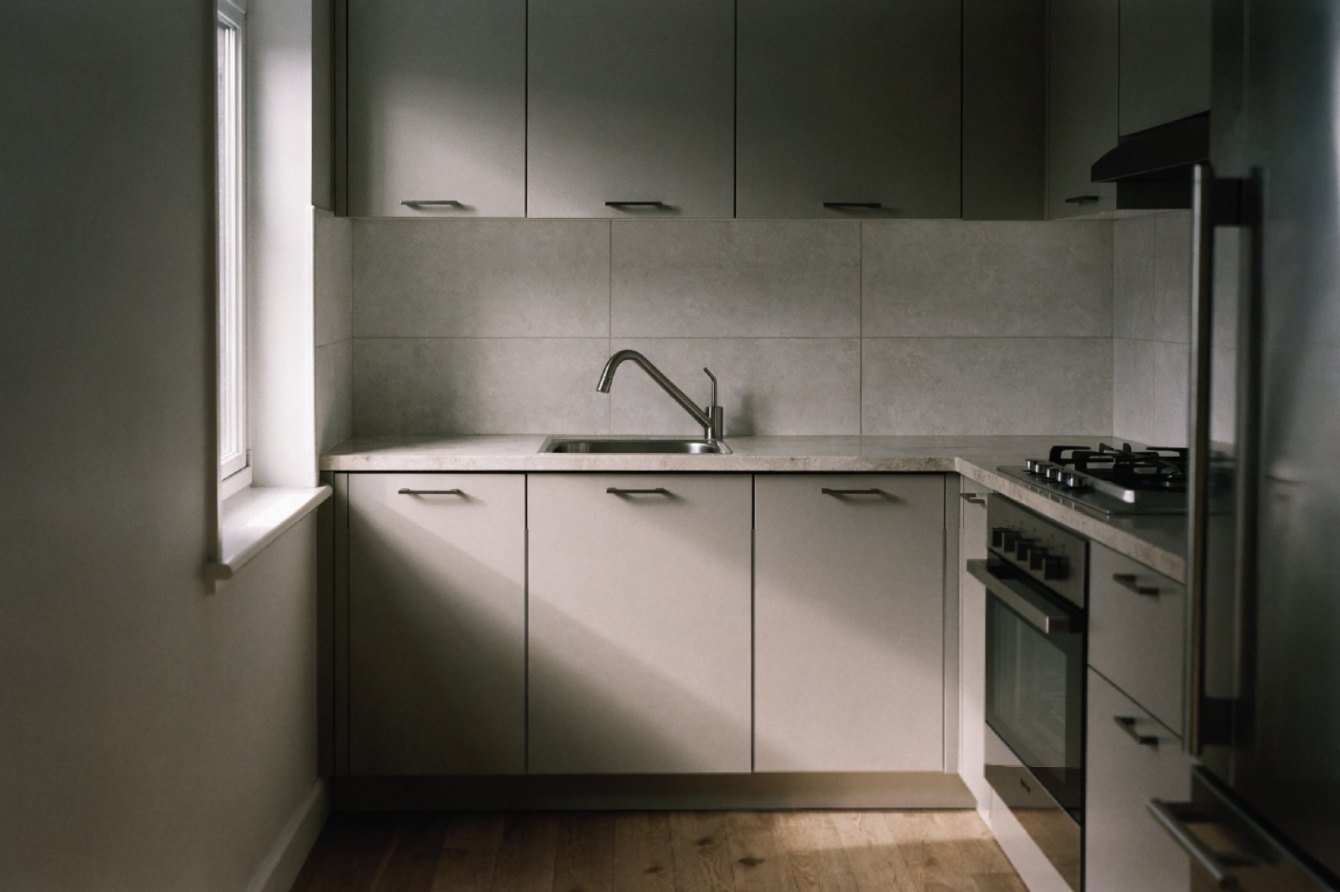 Renovated apartment kitchen with flat-front cabinetry