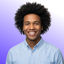 Smiling young man with curly hair wearing a light blue button-up shirt against a purple gradient background.