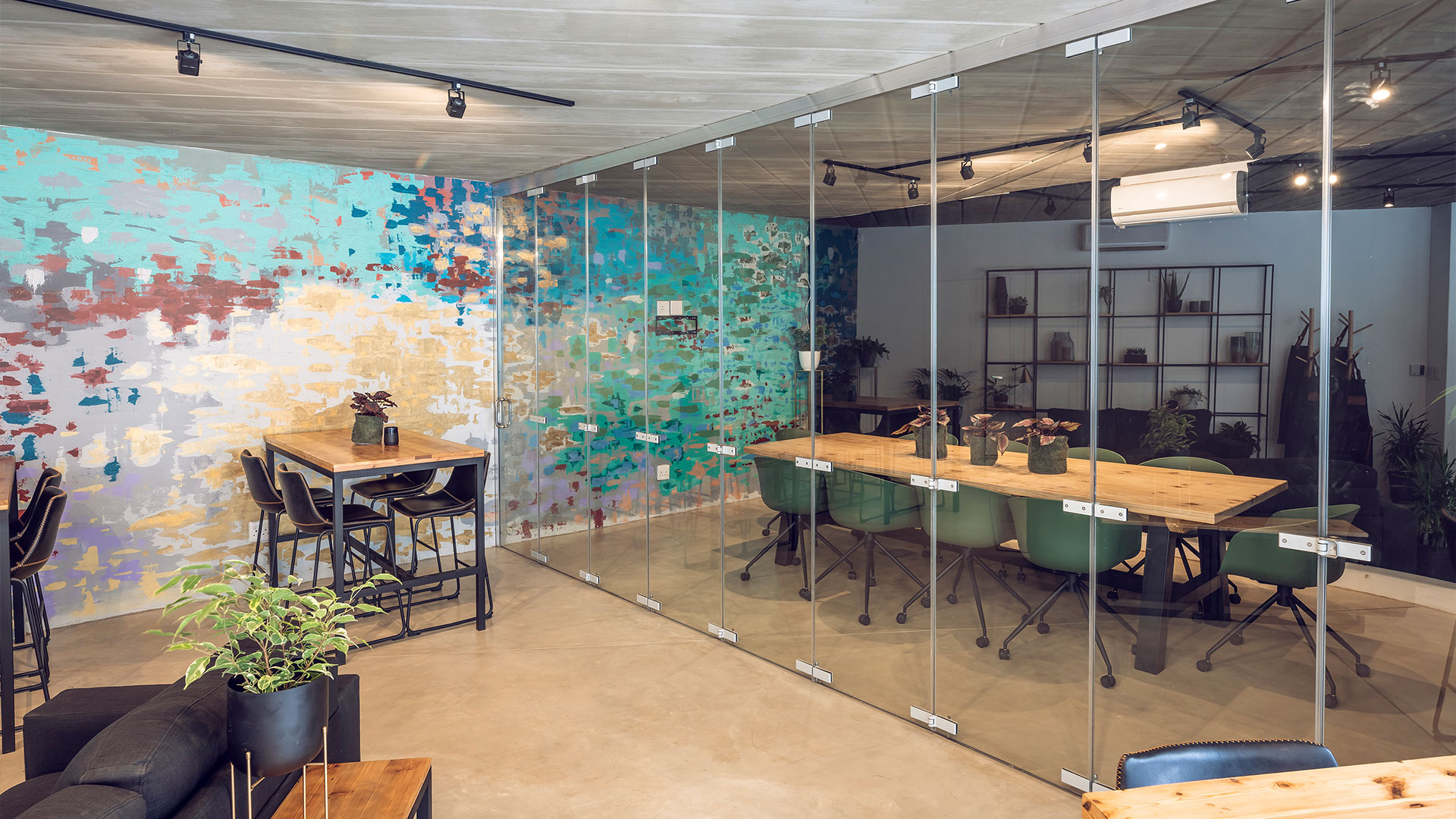 Echo boardroom viewed from outside the folding glass wall standing next to the cafe entrance.