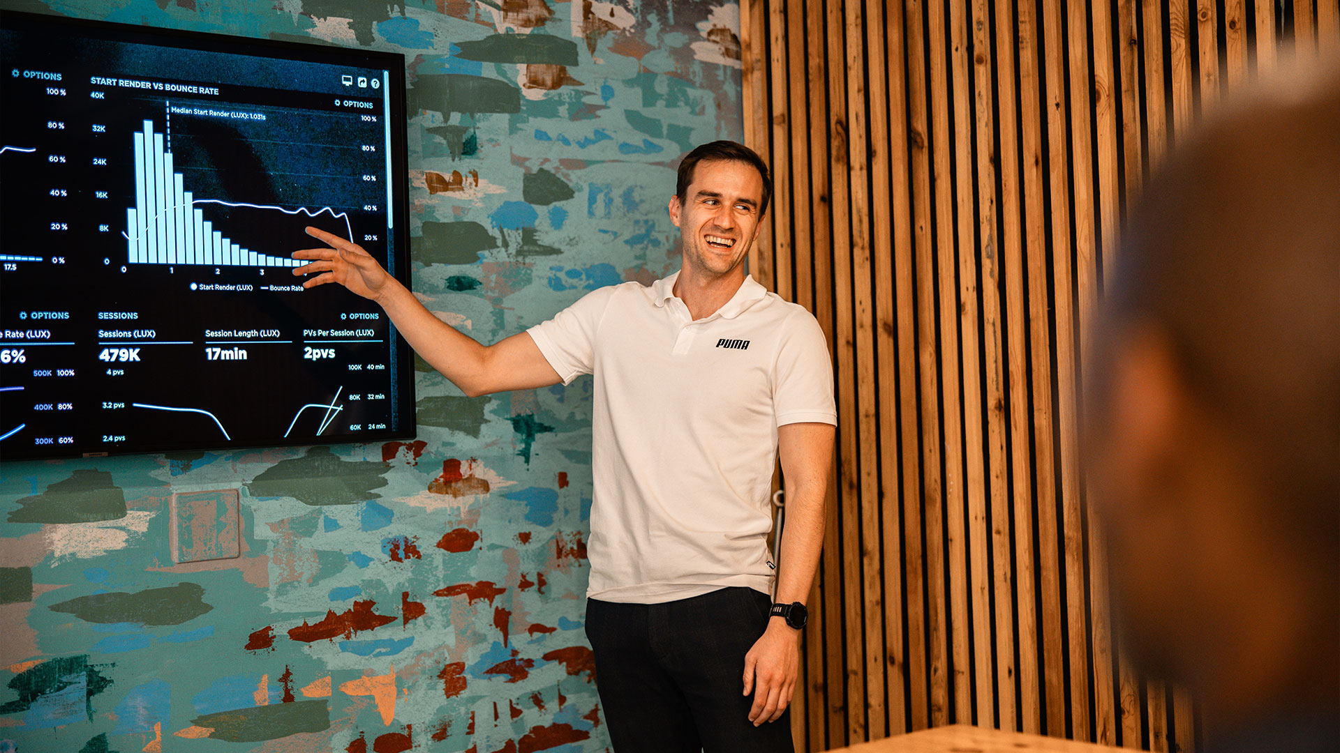 A man has a great time delivering a presentation using echo's boardroom presentation tv screen.