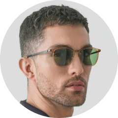 A man wearing sunglasses and a black shirt.