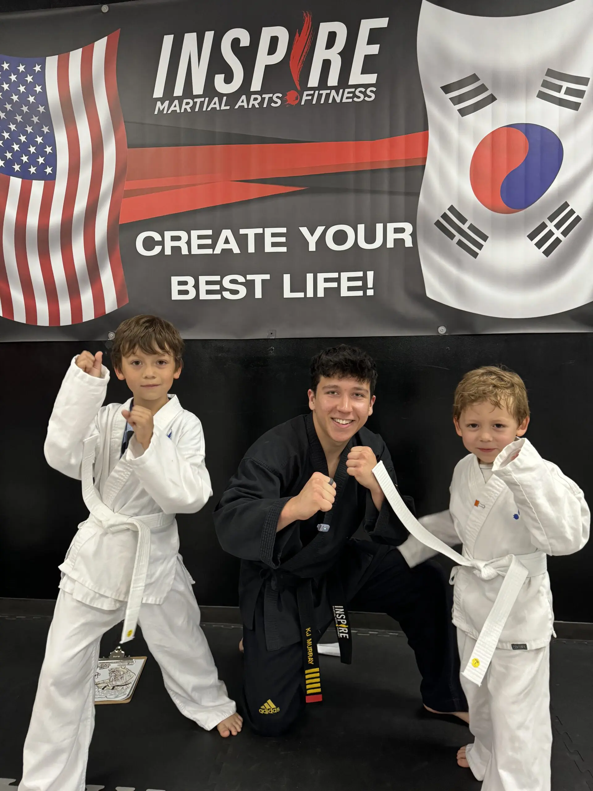Kids practicing taekwondo experience physical benefits and improved overall fitness as they progress through the black belt system, developing coordination, self-discipline, and respect under the guidance of skilled instructors while using protective gear for safe training.