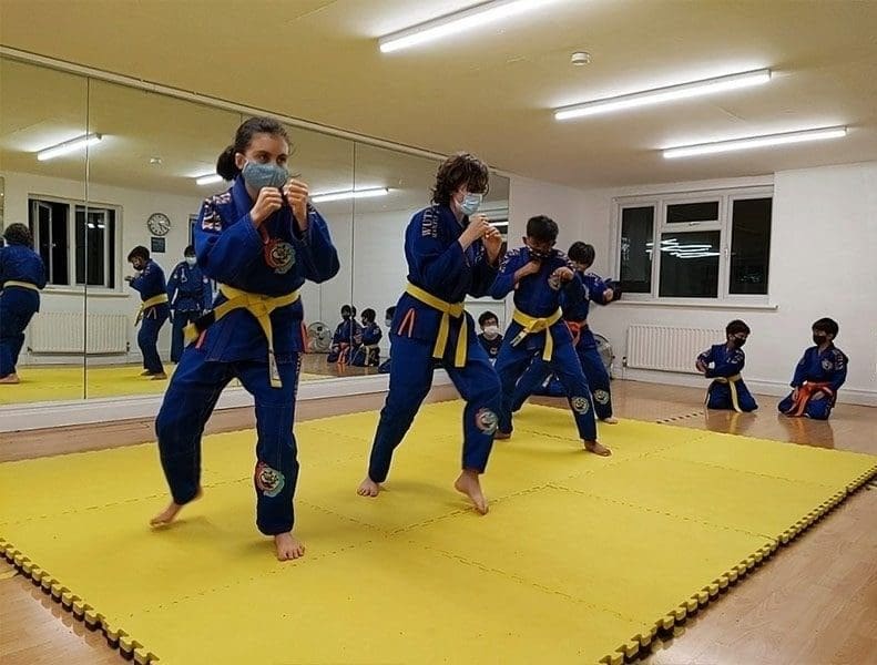 Instructor posing with students after a confidence-building self defense class session.