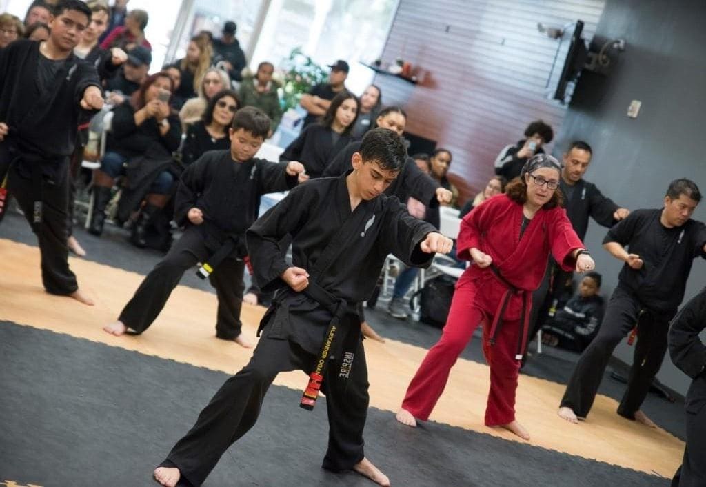 students performing self defense techniques in studio