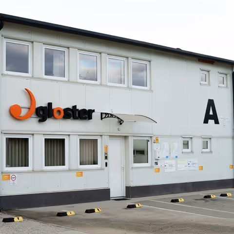 A white building with the letter A and the Gloster logo