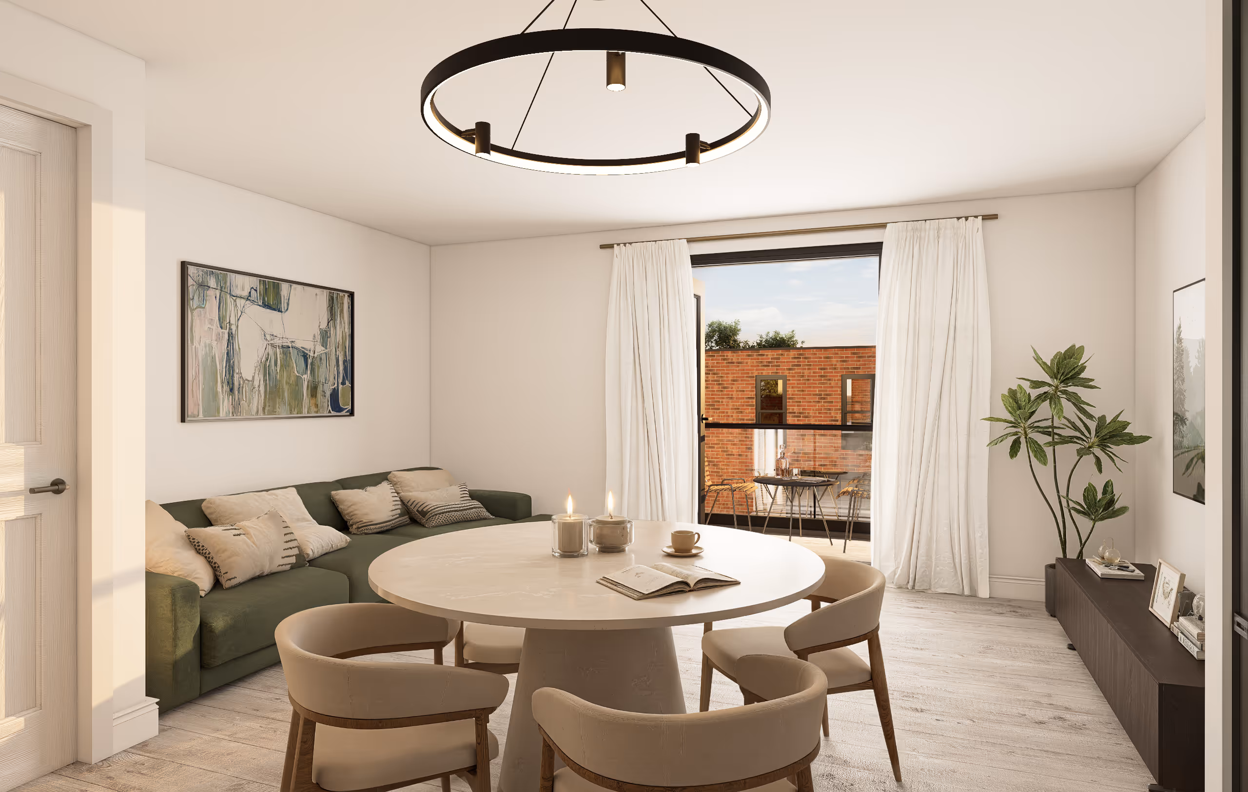 Modern living room with round dining table, beige chairs, green sofa, abstract wall art, and sliding glass door to outdoor patio.