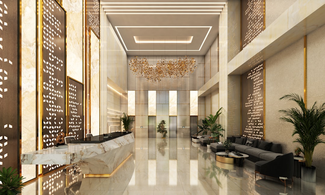 Luxury high-rise lobby with modern art and concierge desk - miami rental apartments