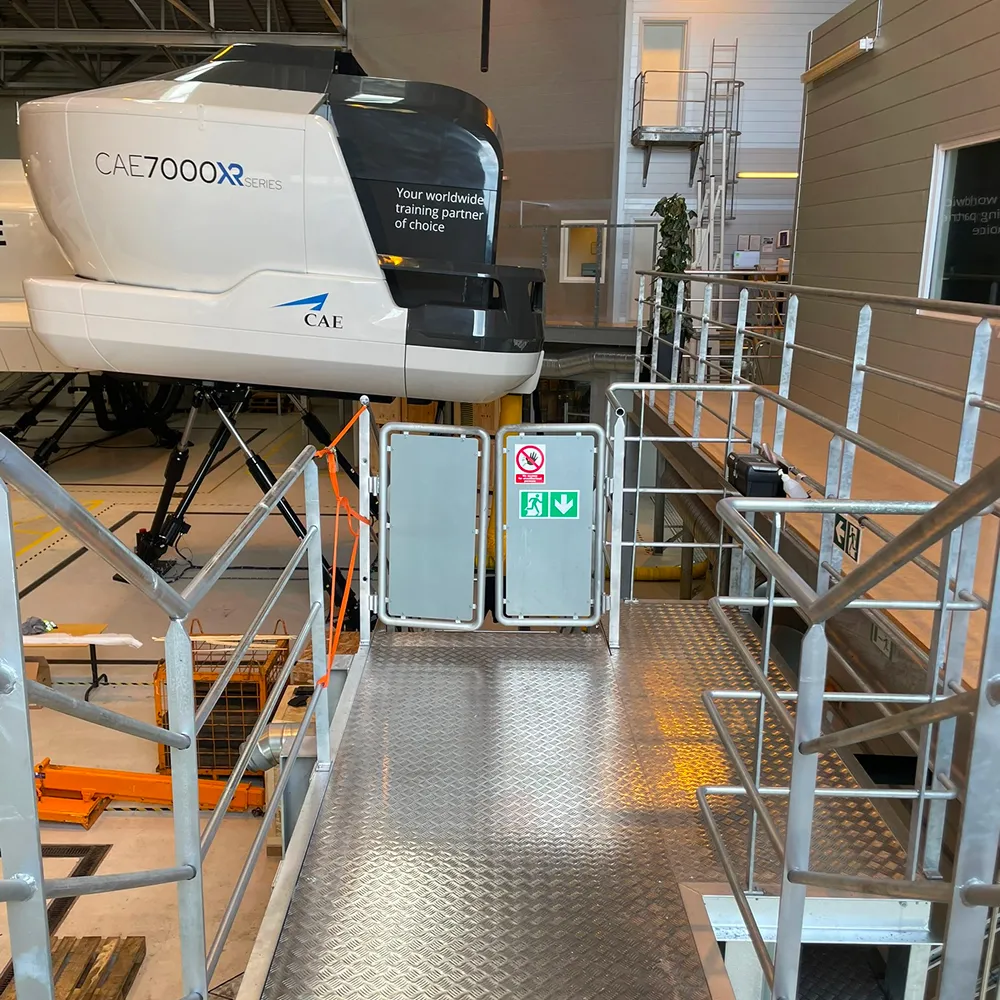 Specialfremstillet adgangsplatform i stål til flysimulator, leveret af smed hos CMP Metal.