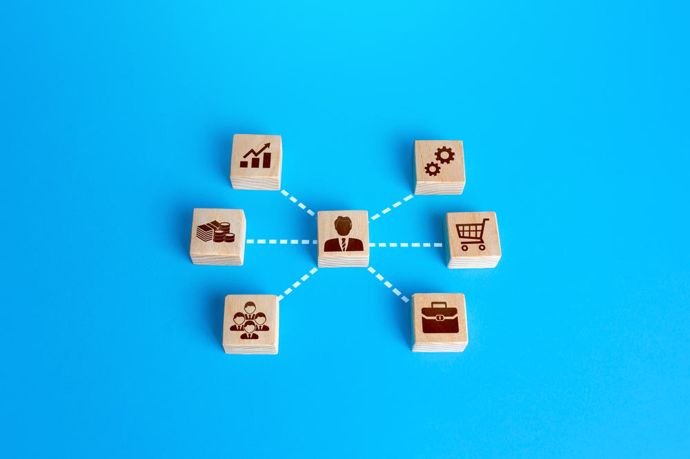 Network diagram showing businessperson connected to growth, settings, finance, shopping, team, and briefcase icons