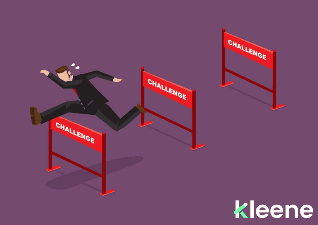 Businessman jumping over three progressively higher red challenge hurdles.