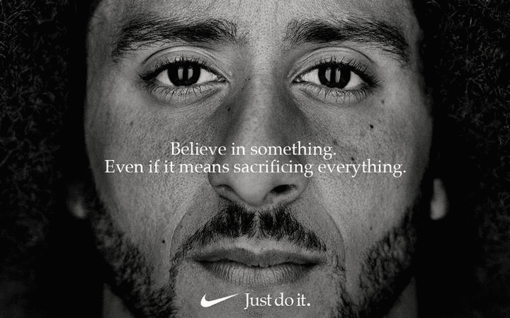 Black and white portrait of man with motivational text "Believe in something" and Nike logo