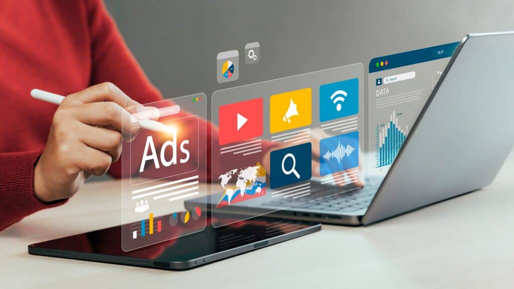 Person selecting digital advertising and app icons floating from laptop screen