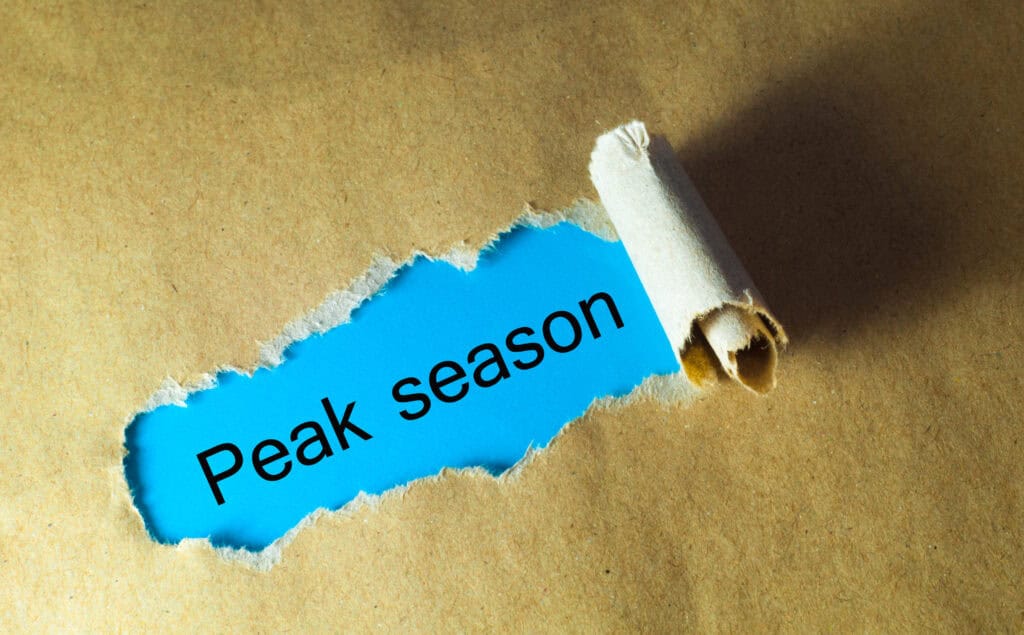 Torn brown paper revealing blue background with "Peak season" text and white scroll