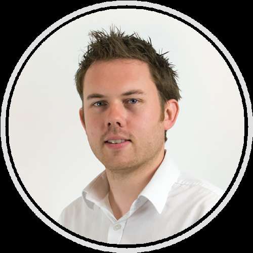 Professional headshot portrait of a man wearing white shirt against white background