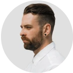 A man with a beard wearing a white shirt.