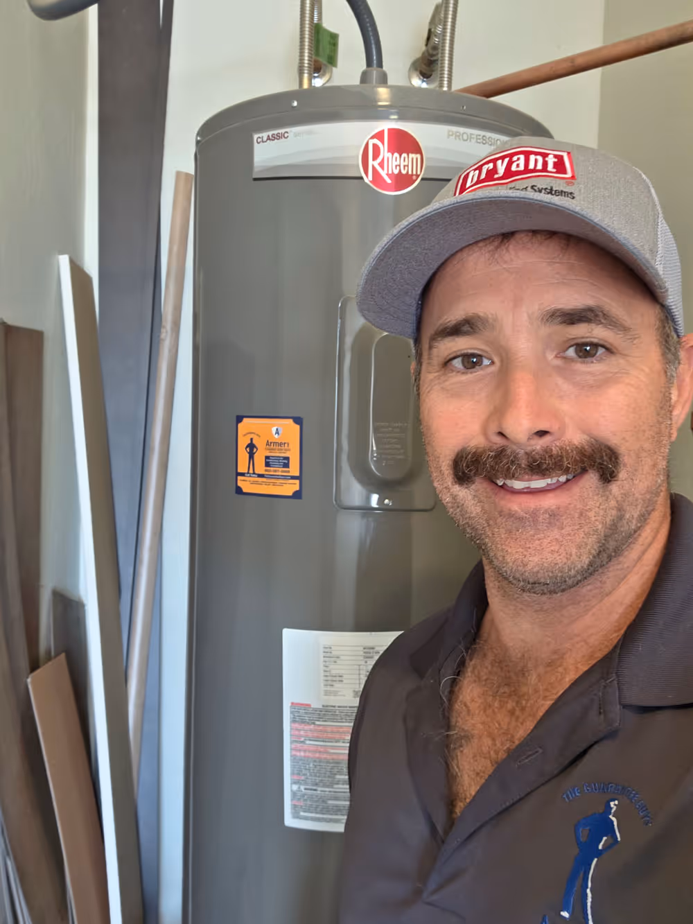 The Guarantee Guys technician stood next to boiler.